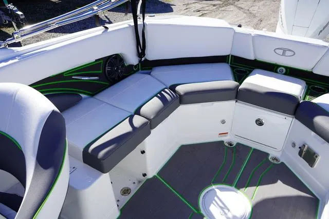 Slide: The Image of 2024 Tahoe 210 S boat interior with white and gray seating, green accents. - 17