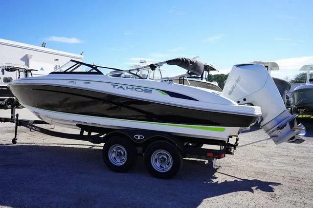 Slide: The Image of 2024 Tahoe 210 S boat on trailer, side view, outdoors, sunny day. - 4
