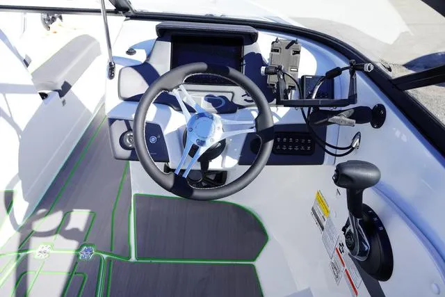 Slide: The Image of 2024 Tahoe 210 S boat cockpit with steering wheel and control panel. - 6