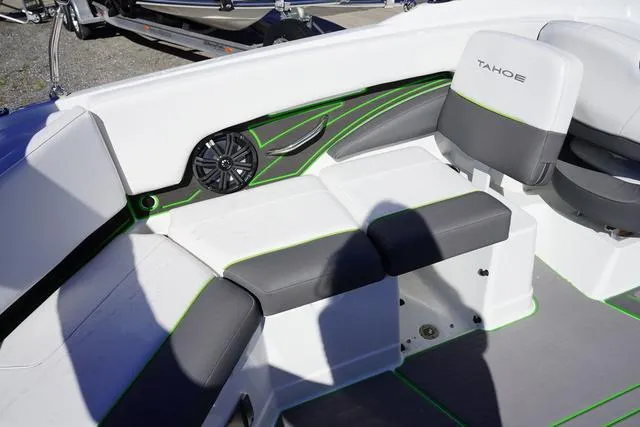 Slide: The Image of 2024 Tahoe 210 S boat interior with gray and white seating, green accents. - 8