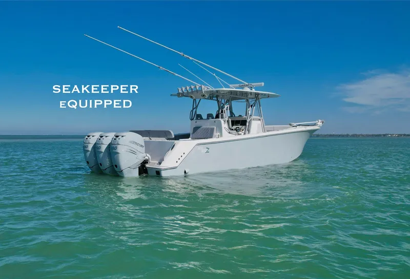 Slide: The Image of 2020 SeaVee 370z boat with Seakeeper, floating on calm turquoise water. - 0