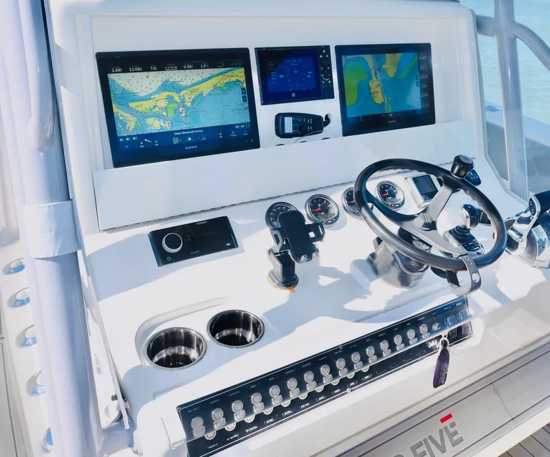 Slide: The Image of 2020 SeaVee 370z boat dashboard with navigation screens and steering wheel. - 21