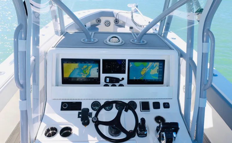 Slide: The Image of 2020 SeaVee 370z boat dashboard with dual navigation screens and steering wheel. - 23
