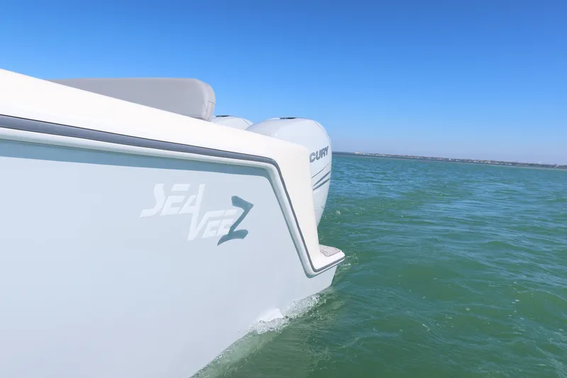 Slide: The Image of 2020 SeaVee 370z boat cruising on clear blue water. - 27