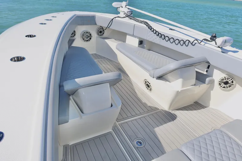 Slide: The Image of 2020 SeaVee 370z boat interior with cushioned seating and modern design on calm water. - 29