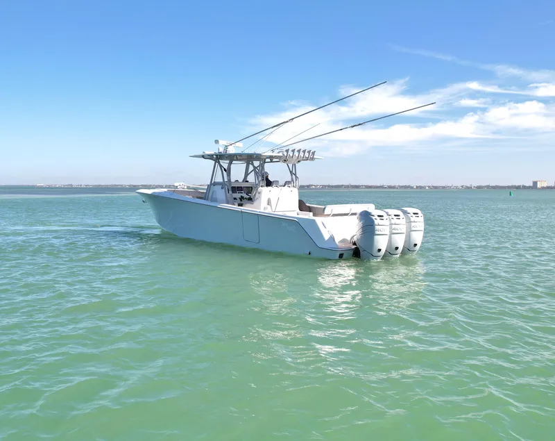 Slide: The Image of 2020 SeaVee 370z boat with triple outboard engines on calm water. - 6