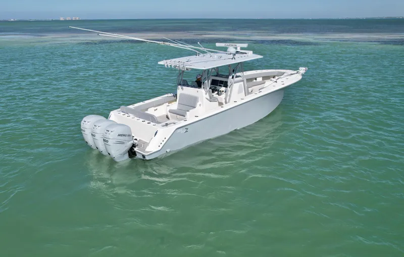 Slide: The Image of 2020 SeaVee 370z boat on calm turquoise water, featuring dual outboard engines. - 7