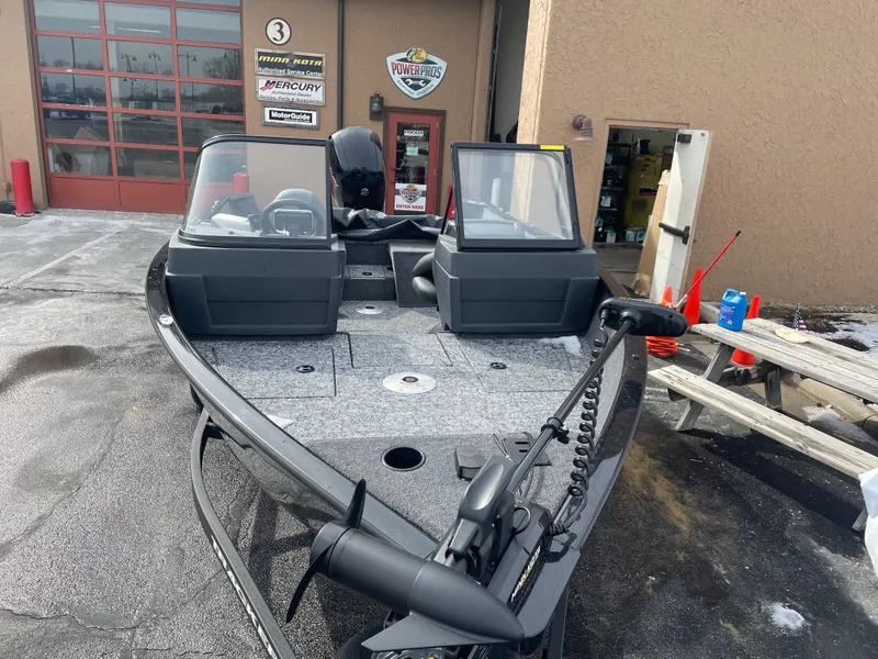 Slide: The Image of 2025 Tracker Pro Guide V-175 Combo boat parked outside a dealership. - 3