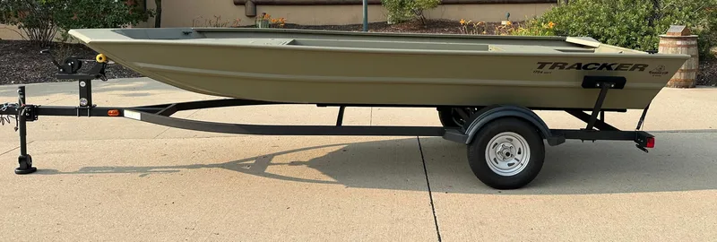 The Image of 2025 Tracker Grizzly 1754 Jon boat on trailer, parked outdoors. - 0