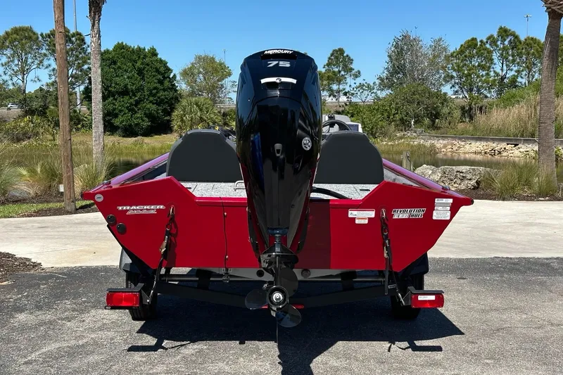 Slide: The Image of 2025 Tracker Pro Team 175 boat, rear view, red color, parked outdoors. - 3