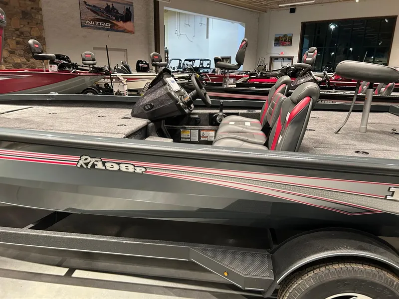 The Image of 2025 Ranger RT198P boat interior with seating and steering console in showroom. - 0