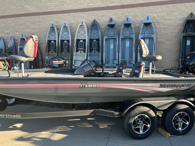 The Image of 2025 Ranger RT188P fishing boat on trailer, parked outdoors, side view. - 0