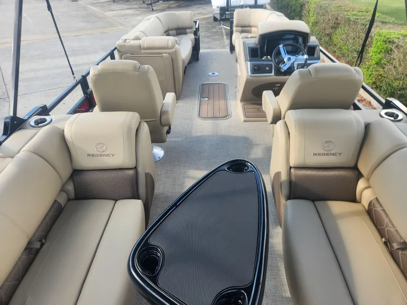Slide: The Image of 2025 Regency 230 LE3 pontoon boat interior with luxurious seating and modern helm. - 4