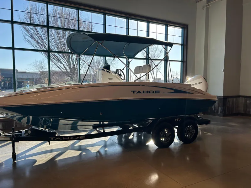 The Image of 2025 Tahoe 2150 CC boat displayed indoors on a trailer. - 0