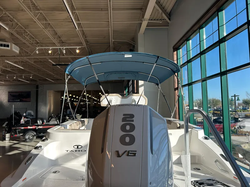 Slide: The Image of 2025 Tahoe 2150 CC boat with 200 V6 engine displayed indoors. - 2