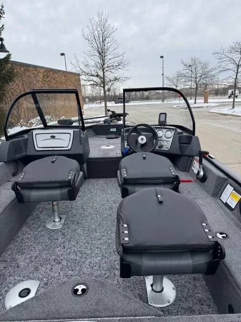 Slide: The Image of 2025 Tracker Pro Guide V-16 WT boat interior with seating and steering wheel. - 2