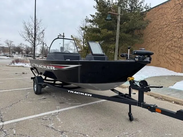 Slide: The Image of 2025 Tracker Pro Guide V-16 WT boat on trailer in parking lot. - 3