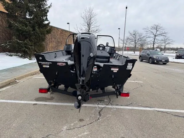 Slide: The Image of 2025 Tracker Pro Guide V-16 WT boat parked in a snowy lot. - 7