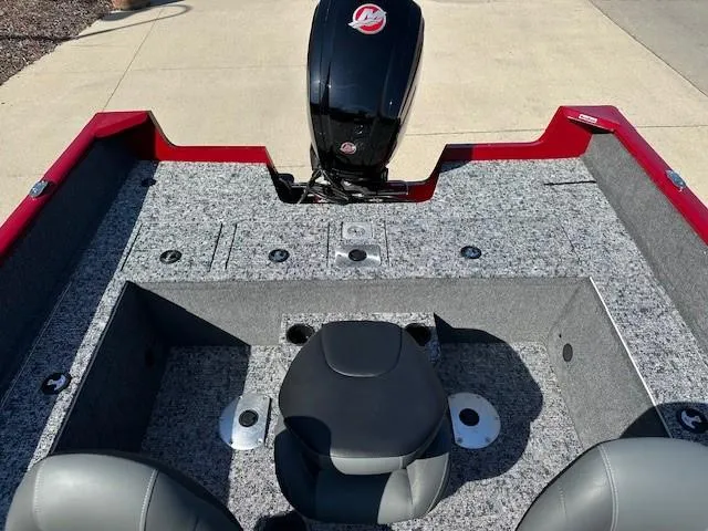 Slide: The Image of 2025 Tracker Pro Guide V-175 WT boat interior with motor, red and gray design. - 7