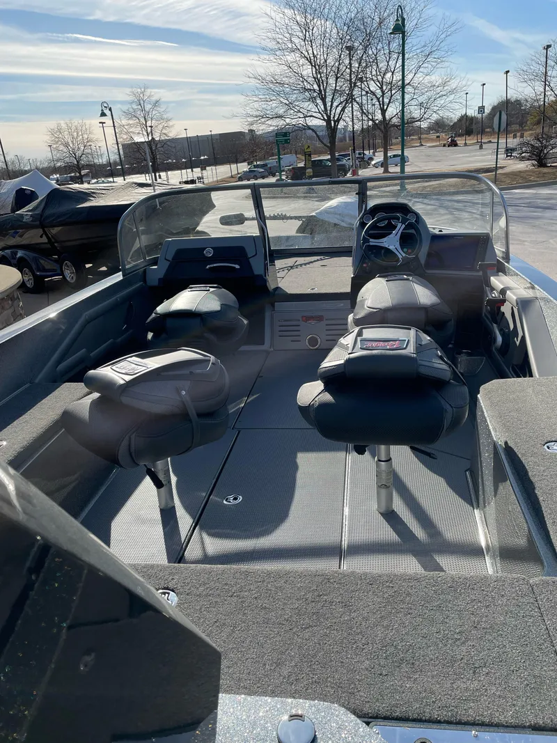 Slide: The Image of 2024 Ranger 621FS Ranger Cup Equipped boat interior with seating and steering wheel. - 2