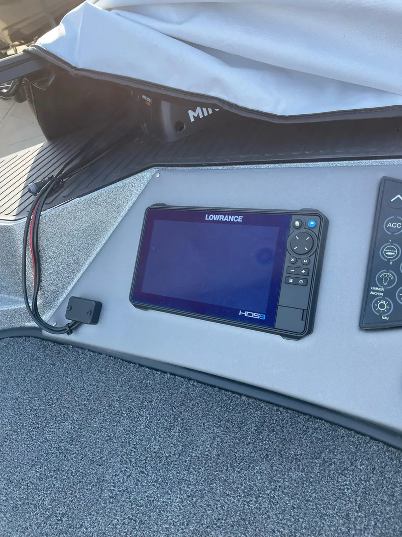 Slide: The Image of 2024 Ranger 621FS boat dashboard with Lowrance HDS display and controls. - 5