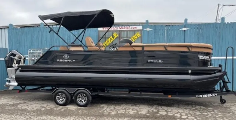 Slide: The Image of 2024 Regency 250 LE3 Sport pontoon boat with black exterior on trailer. - 1
