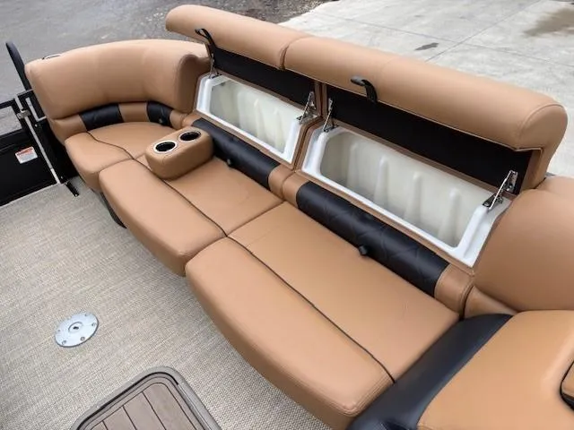 Slide: The Image of 2024 Regency 250 LE3 Sport boat interior with tan seating and storage compartments. - 10