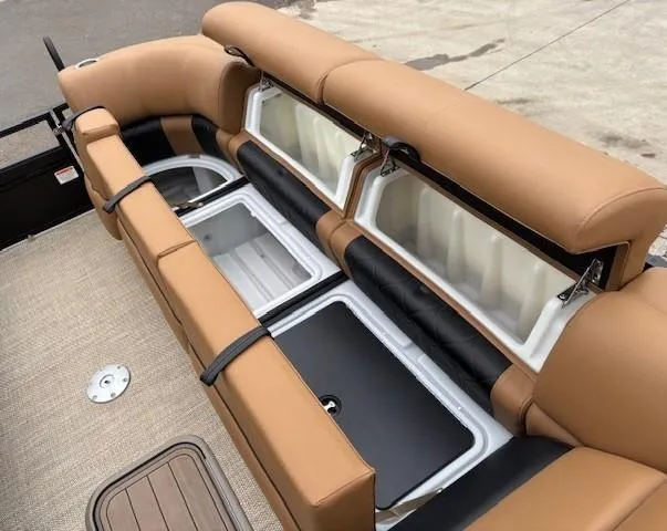 Slide: The Image of 2024 Regency 250 LE3 Sport boat interior with tan seating and storage compartments. - 11