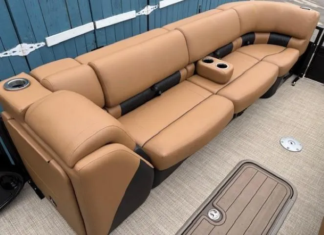 Slide: The Image of 2024 Regency 250 LE3 Sport boat interior with tan leather seating and cup holders. - 12