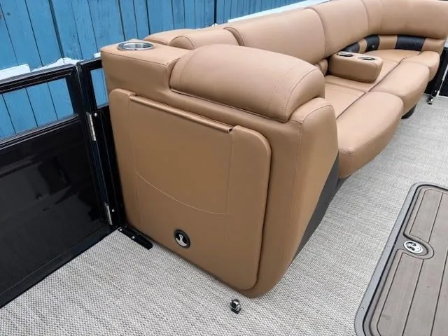 Slide: The Image of 2024 Regency 250 LE3 Sport boat interior with tan seating and cup holders. - 15