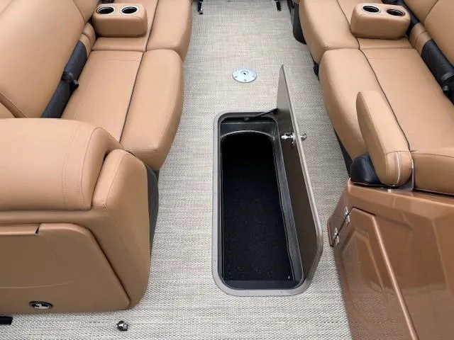 Slide: The Image of 2024 Regency 250 LE3 Sport interior with tan seating and open storage compartment. - 17