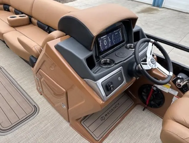 Slide: The Image of 2024 Regency 250 LE3 Sport boat interior with tan seating and modern dashboard. - 18