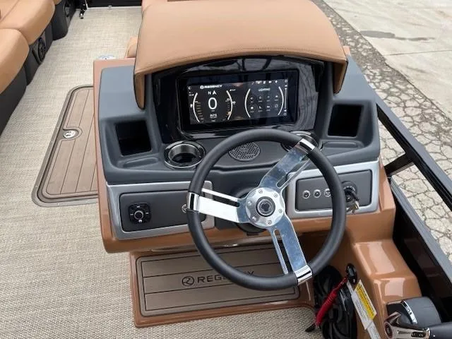 Slide: The Image of 2024 Regency 250 LE3 Sport dashboard with steering wheel and digital display. - 19