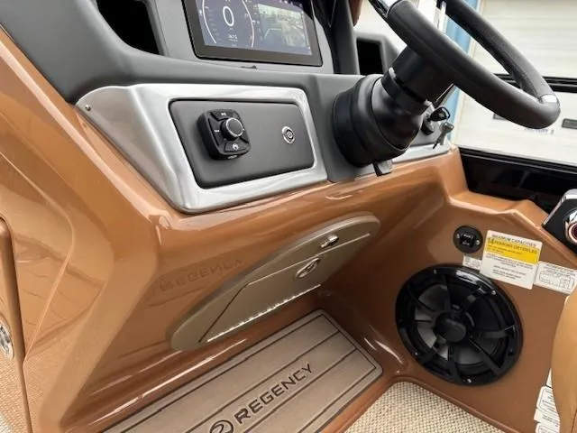 Slide: The Image of 2024 Regency 250 LE3 Sport dashboard with steering wheel and control panel. - 21