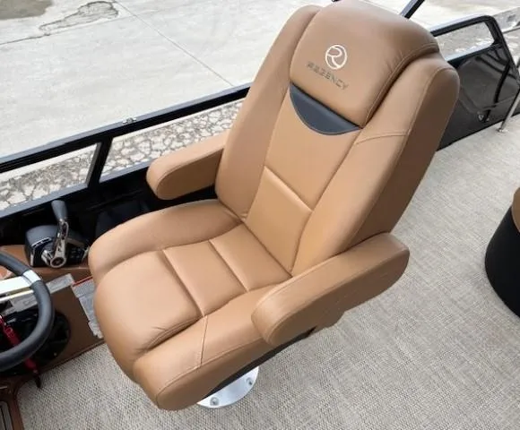Slide: The Image of Luxurious tan captain's chair in 2024 Regency 250 LE3 Sport boat interior. - 23