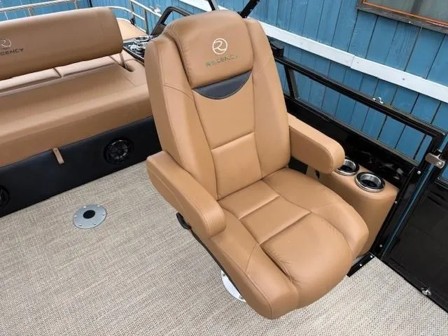 Slide: The Image of 2024 Regency 250 LE3 Sport boat seat, tan leather, cup holders, luxurious design. - 24