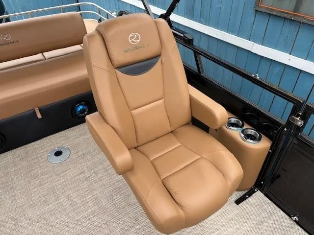 Slide: The Image of 2024 Regency 250 LE3 Sport boat seat, tan leather, with cup holders and armrests. - 25
