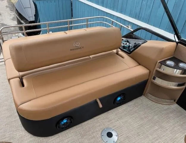 Slide: The Image of 2024 Regency 250 LE3 Sport boat interior with tan seating and modern controls. - 26