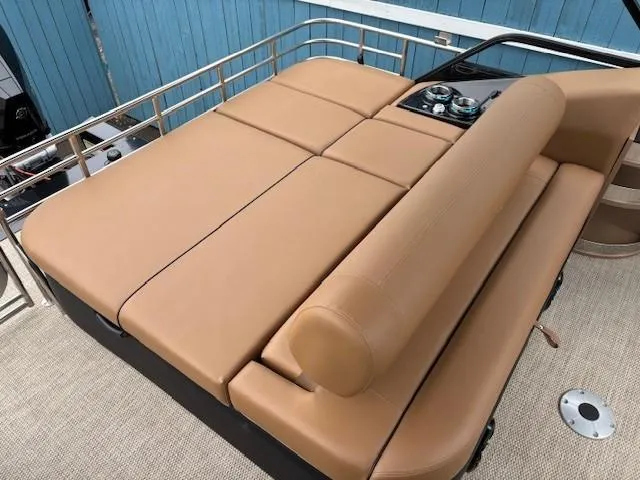 Slide: The Image of 2024 Regency 250 LE3 Sport boat with tan leather seating and control panel. - 27