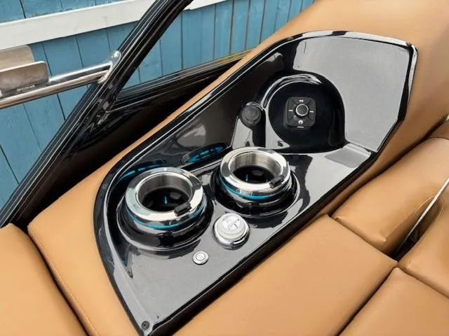 Slide: The Image of 2024 Regency 250 LE3 Sport boat console with cup holders and controls. - 29