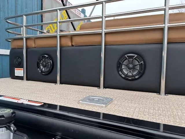 Slide: The Image of 2024 Regency 250 LE3 Sport boat with speakers and cushioned seating. - 32