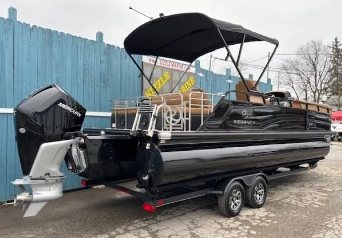 Slide: The Image of 2024 Regency 250 LE3 Sport pontoon boat with Mercury outboard engine, parked on a trailer. - 4