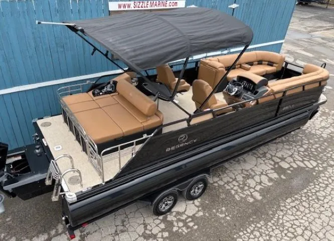 Slide: The Image of 2024 Regency 250 LE3 Sport pontoon boat with black canopy and tan seating. - 6