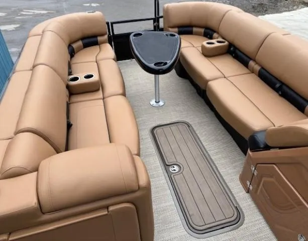 Slide: The Image of 2024 Regency 250 LE3 Sport pontoon boat interior with tan seating and table. - 7