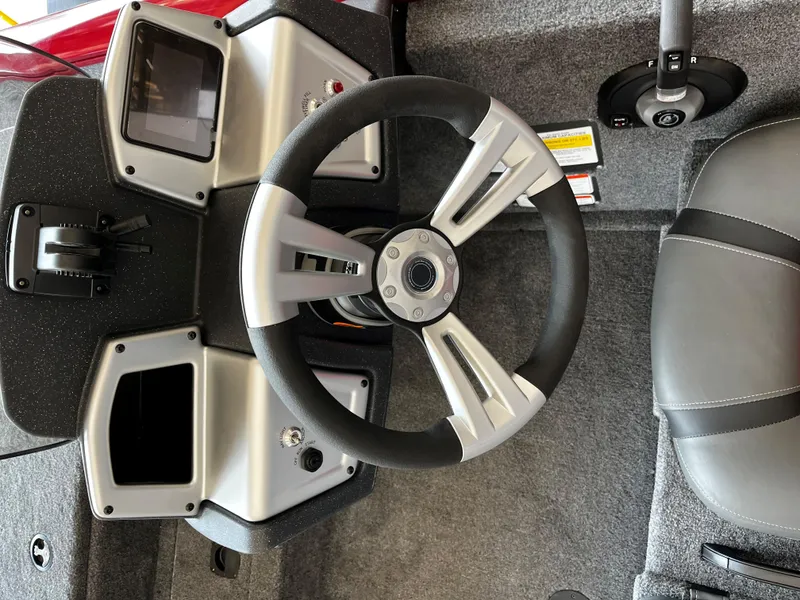 Slide: The Image of Steering wheel of 2025 Tracker Pro Team 195 Tournament Edition boat, featuring modern dashboard design. - 2