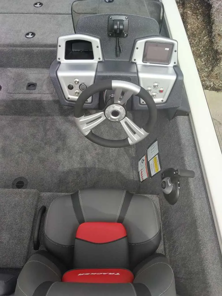 Slide: The Image of 2025 Tracker Pro Team 195 Tournament Edition boat cockpit with steering wheel and control panel. - 5