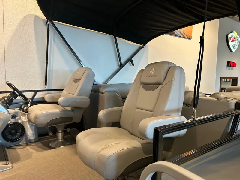 Slide: The Image of 2024 Regency 250 LE3 boat interior with steering console and seating. - 2