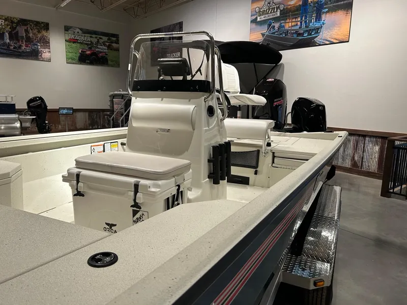 Slide: The Image of 2025 Ranger RB210 boat on trailer, featuring a powerful outboard motor. - 2