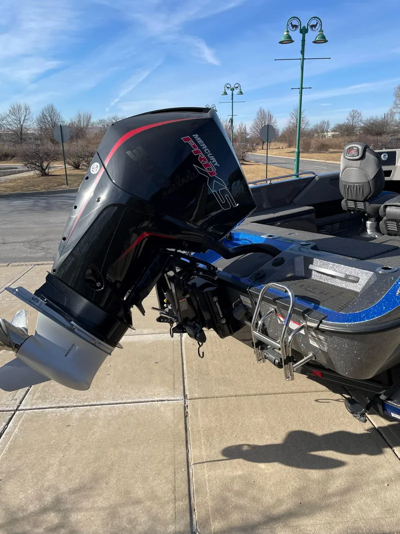Slide: The Image of 2024 Ranger 620FS Pro boat with powerful outboard motor, parked on a sunny day. - 1
