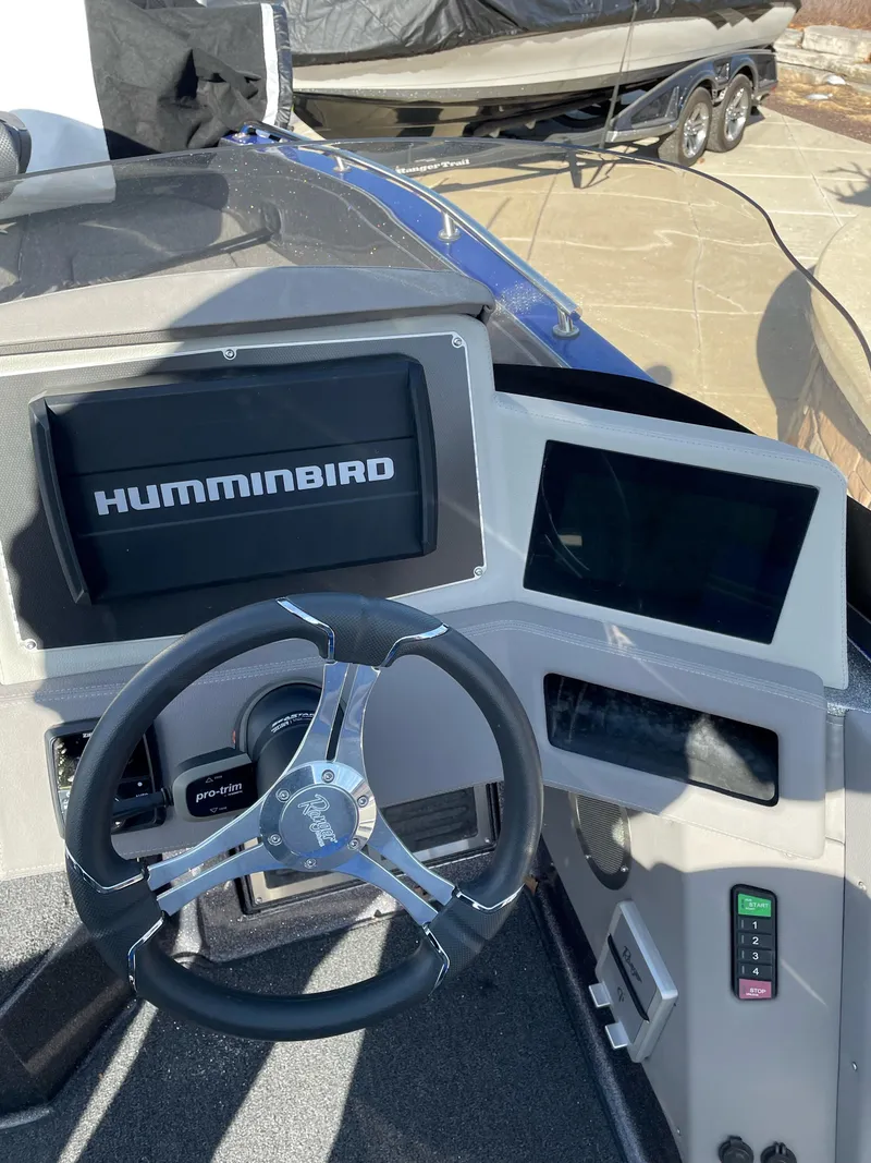Slide: The Image of 2024 Ranger 620FS Pro boat dashboard with Humminbird electronics and steering wheel. - 2